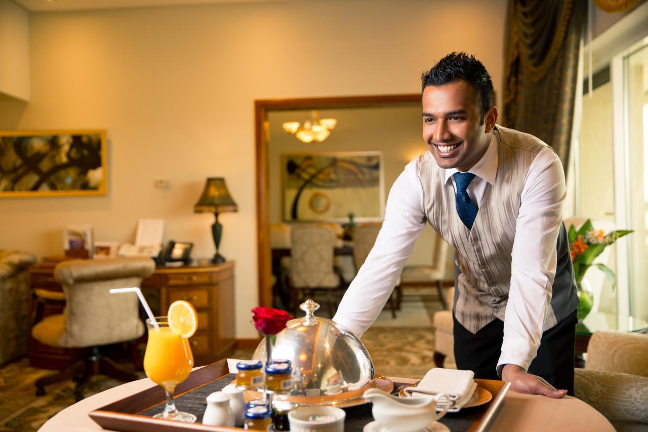 Officers Club & Hotel Абу Даби Екстериор снимка A room service attendant